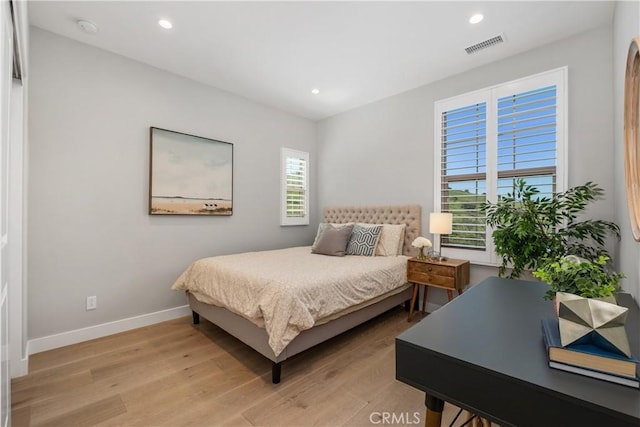 bedroom featuring recessed lighting, visible vents, light wood-type flooring, and baseboards