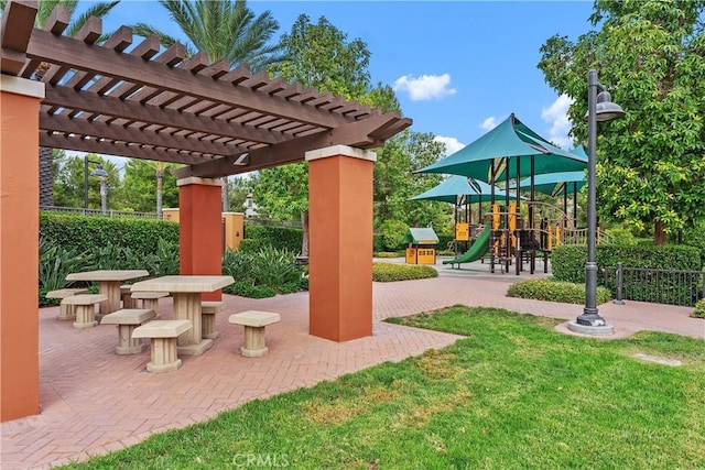 view of patio / terrace with playground community, fence, and a pergola