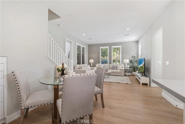 dining area featuring stairway, recessed lighting, light wood-style floors, and baseboards