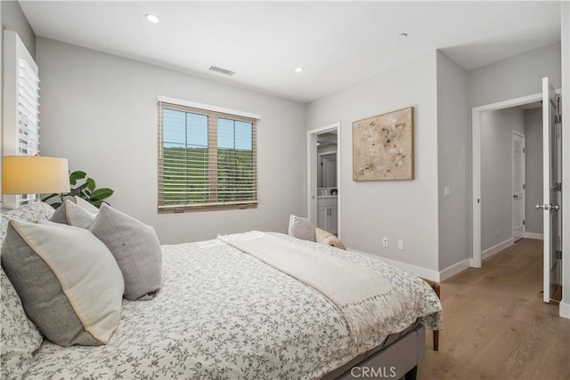 bedroom with visible vents, recessed lighting, wood finished floors, and baseboards