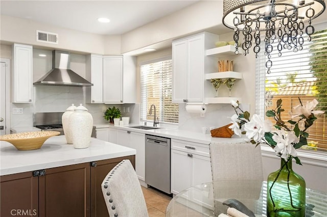 kitchen featuring visible vents, open shelves, a sink, dishwasher, and wall chimney exhaust hood