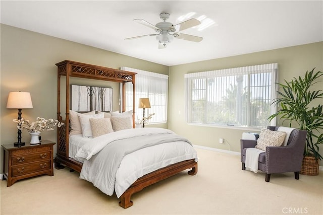 carpeted bedroom with baseboards and ceiling fan