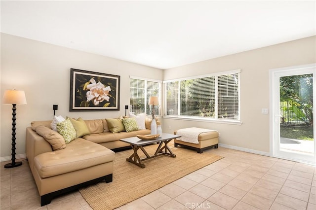 living area with light tile patterned floors and baseboards