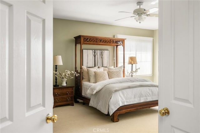 bedroom with a ceiling fan and carpet floors