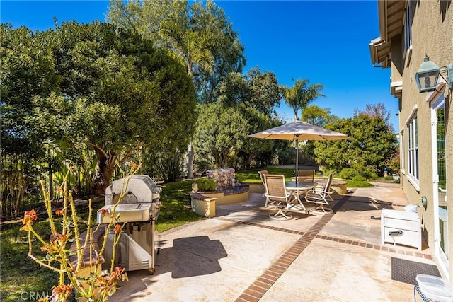 view of patio with outdoor dining area and a grill