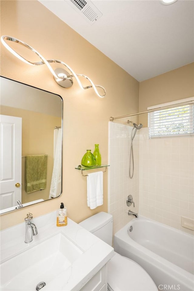 full bathroom with visible vents, toilet, vanity, and shower / bath combination with curtain