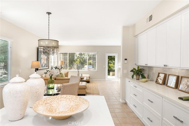 living room featuring light tile patterned flooring, baseboards, and visible vents