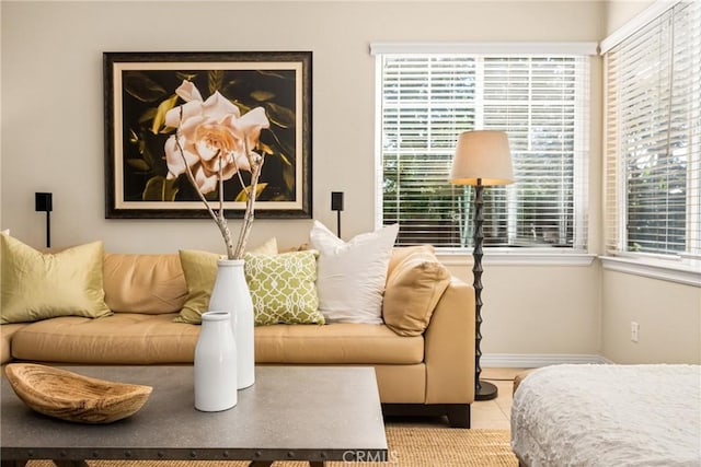 tiled living room featuring baseboards