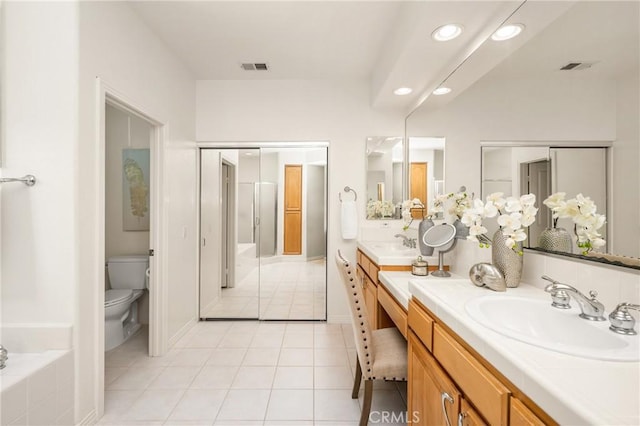 bathroom with tile patterned flooring, toilet, vanity, and visible vents