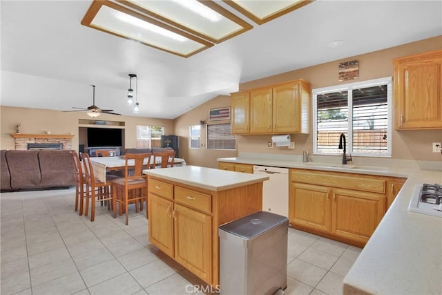 kitchen featuring light brown cabinetry, a sink, open floor plan, light countertops, and dishwasher