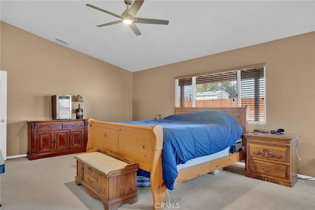 bedroom with visible vents, baseboards, light colored carpet, vaulted ceiling, and a ceiling fan