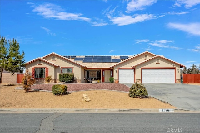 20368 Majestic Dr, Apple Valley, CA 92308 - single story home with stucco siding, an attached garage, roof mounted solar panels, a tiled roof, and stone siding