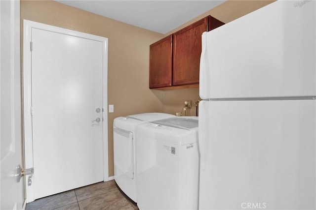 20368 Majestic Dr, Apple Valley, CA 92308 - laundry area featuring washer and dryer, cabinet space, and light tile patterned floors