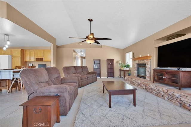 living room with lofted ceiling, light tile patterned flooring, a fireplace, and ceiling fan