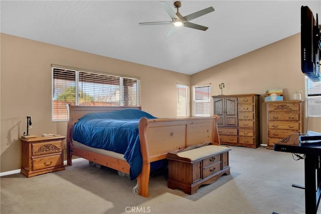 bedroom featuring ceiling fan, vaulted ceiling, baseboards, and light carpet