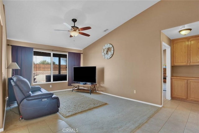 living room featuring baseboards, visible vents, lofted ceiling, light tile patterned flooring, and ceiling fan