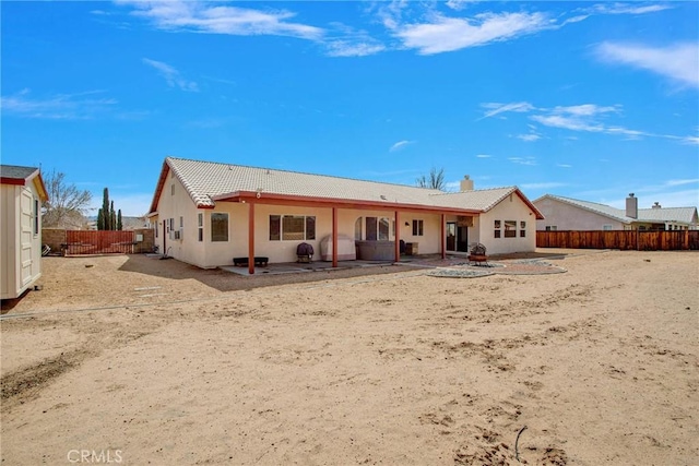 back of property featuring a patio, a tiled roof, a fenced backyard, and stucco siding