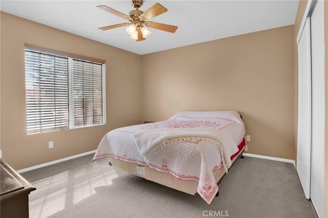 bedroom featuring a closet, a ceiling fan, baseboards, and carpet floors