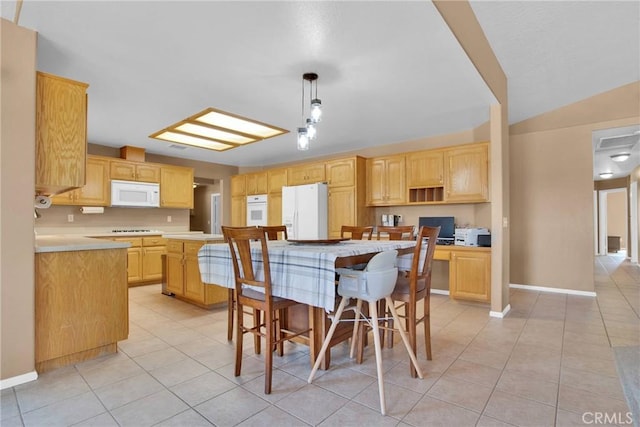 kitchen with white appliances, light tile patterned flooring, light countertops, and light brown cabinetry