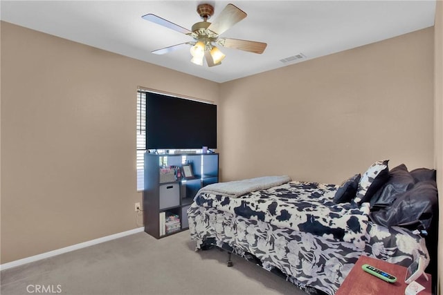 carpeted bedroom featuring visible vents, a ceiling fan, and baseboards