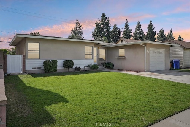 single story home featuring an attached garage, stucco siding, a yard, crawl space, and driveway