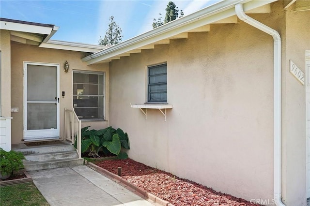 doorway to property with stucco siding