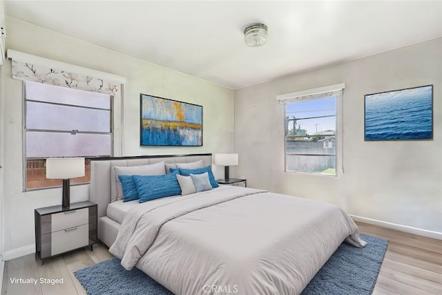 bedroom featuring baseboards and light wood-style flooring