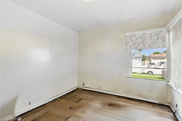 spare room featuring wood-type flooring