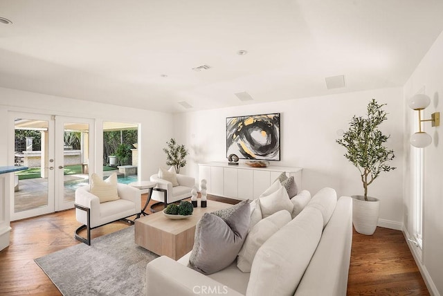 living room with wood finished floors, french doors, visible vents, and baseboards