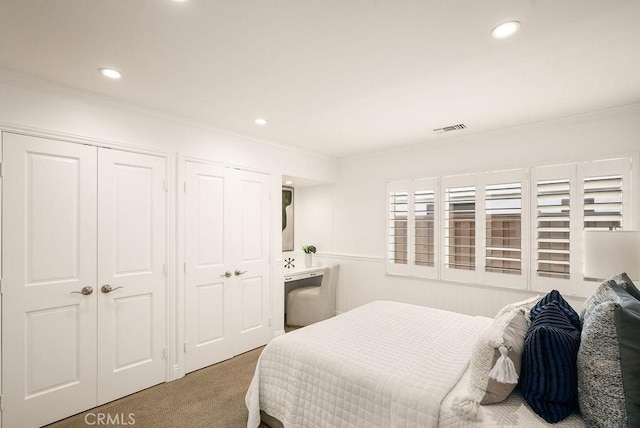 carpeted bedroom with recessed lighting, visible vents, and ornamental molding