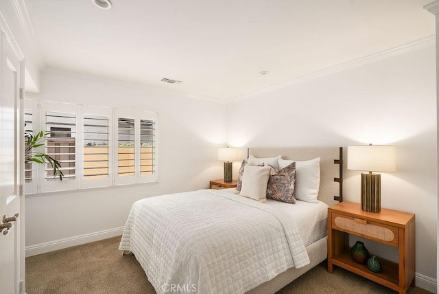 bedroom featuring visible vents, baseboards, ornamental molding, and carpet flooring