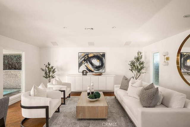 living room featuring visible vents and wood finished floors