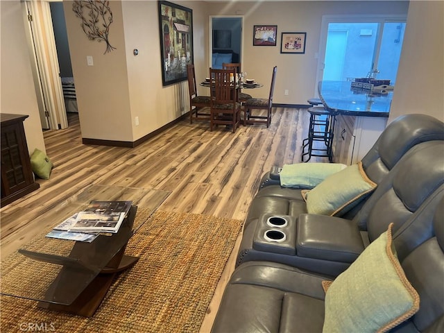 living room featuring baseboards and wood finished floors