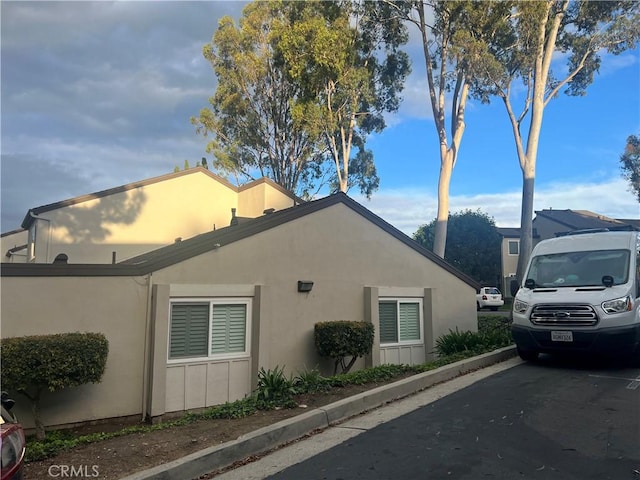 view of side of property with stucco siding