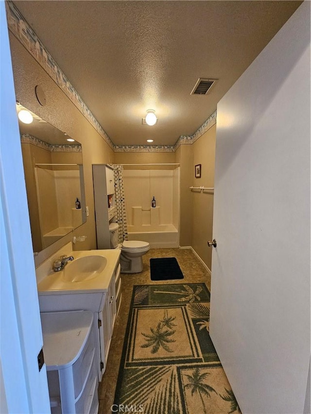 bathroom with vanity, washtub / shower combination, visible vents, a textured ceiling, and toilet