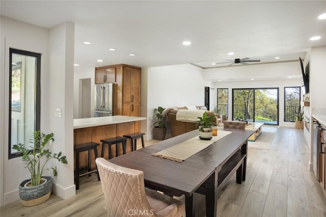 dining room with light wood-style flooring, recessed lighting, baseboards, and ceiling fan