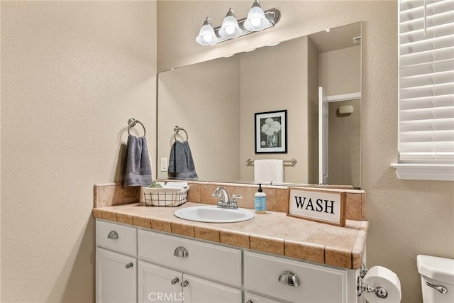 bathroom featuring toilet and vanity