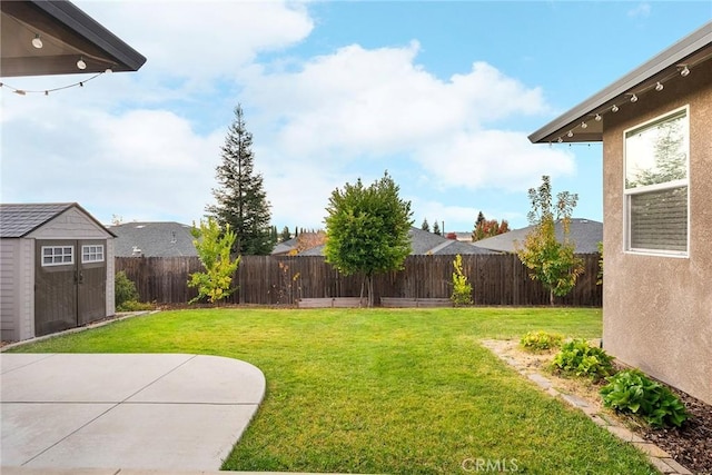 view of yard featuring a patio, an outdoor structure, a fenced backyard, and a shed