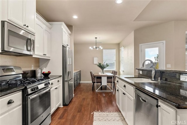 kitchen featuring a sink, stainless steel appliances, white cabinets, and dark wood-style flooring