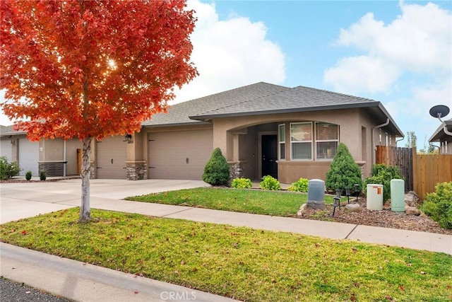 view of front of property with stucco siding, a front lawn, fence, concrete driveway, and a garage