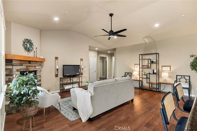 living room featuring dark wood finished floors, a fireplace, baseboards, ceiling fan, and vaulted ceiling