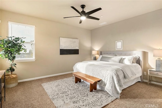 bedroom featuring baseboards, carpet floors, visible vents, and a ceiling fan