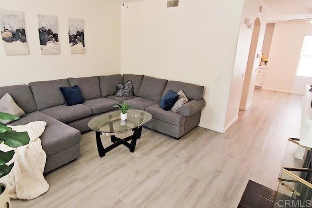 2203 Huntington Point Dr Unit 4, Chula Vista, CA 91914 - living area with light wood finished floors, arched walkways, baseboards, and a ceiling fan