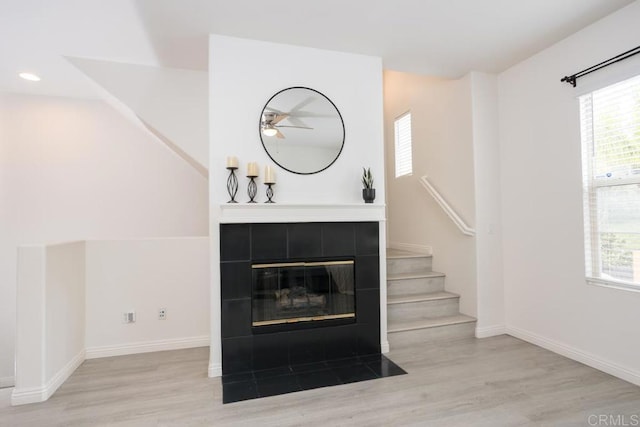 2203 Huntington Point Dr Unit 4, Chula Vista, CA 91914 - unfurnished living room with wood finished floors, plenty of natural light, a ceiling fan, a tile fireplace, and recessed lighting