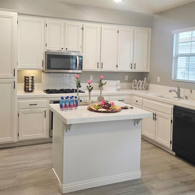 2203 Huntington Point Dr Unit 4, Chula Vista, CA 91914 - kitchen featuring dishwasher, stainless steel microwave, and tile counters