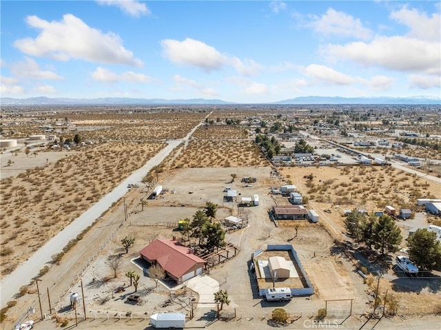 drone / aerial view featuring a mountain view, a rural view, and a desert view