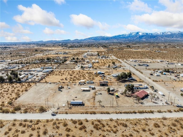 birds eye view of property with a desert view and a mountain view