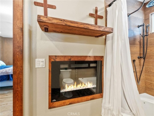 interior details featuring a lit fireplace