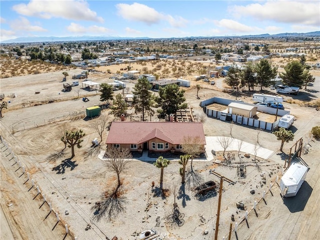 birds eye view of property featuring view of desert and a mountain view