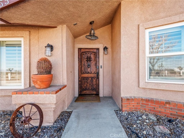 doorway to property with stucco siding